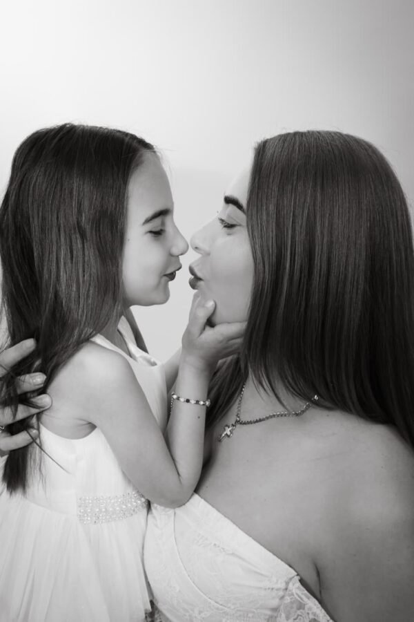 Two girls forehead to forehead, in black and white