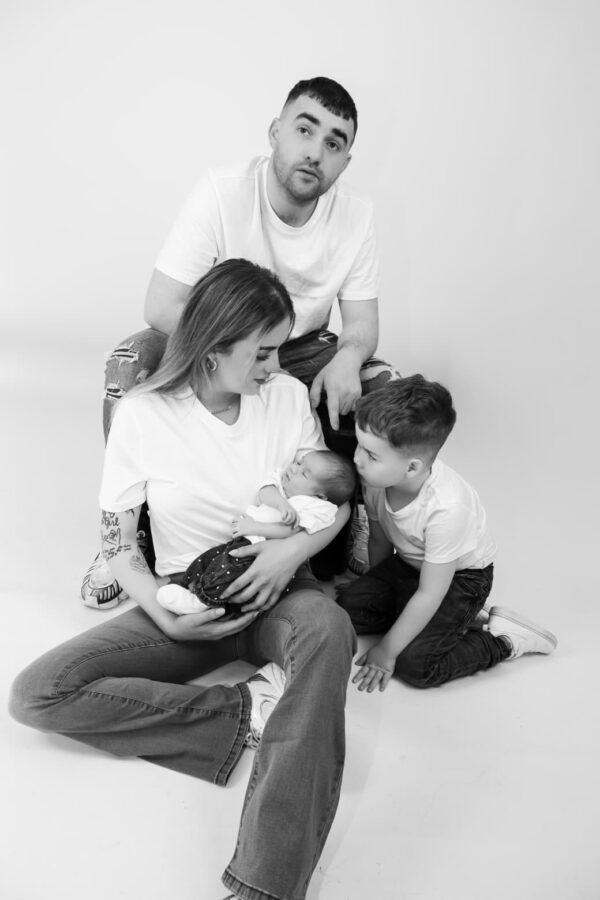A father, mother and children together in black and white