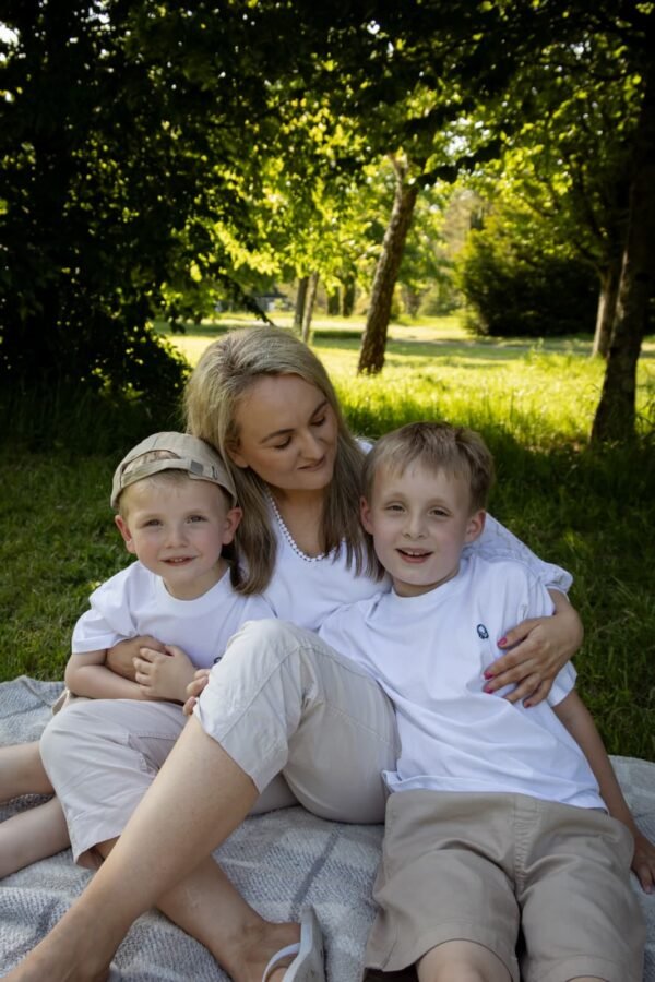 A mother with her three children on the grass