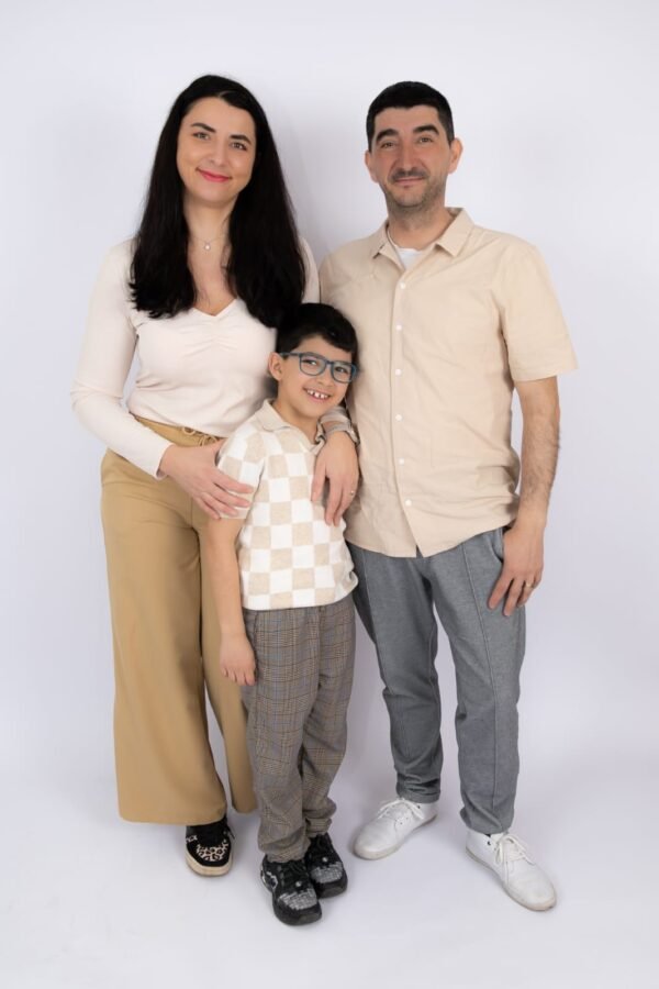A family of three in soft neutral tones