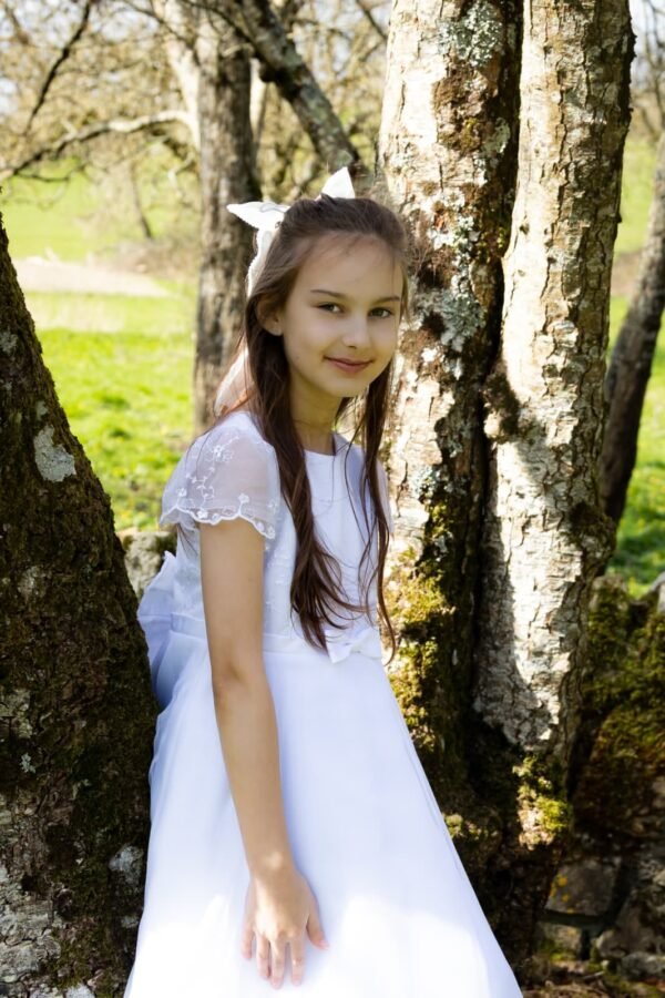 A Communion girl among the trees