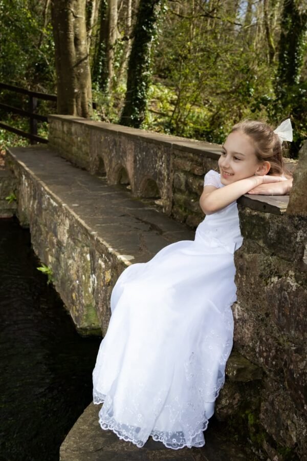 A Communion girl on a stone bridge