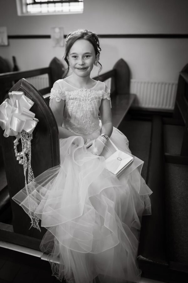 A First Communion girl photographed indoors
