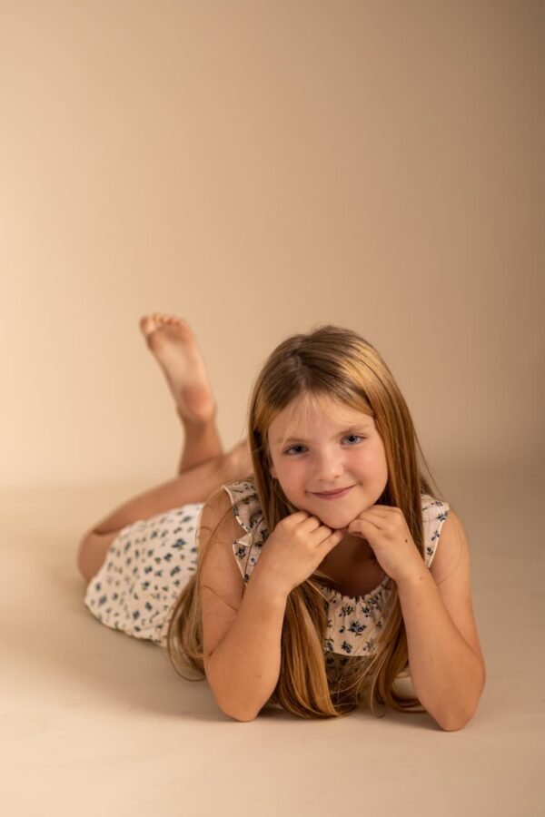 A girl lying down and smiling at a studio session