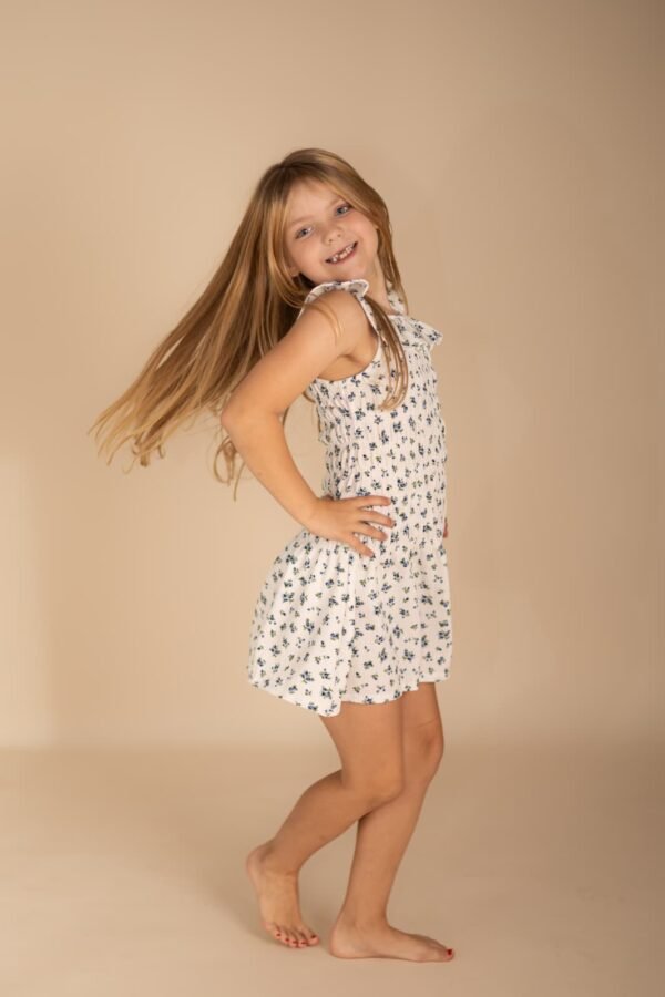 A girl in a floral dress at a studio session