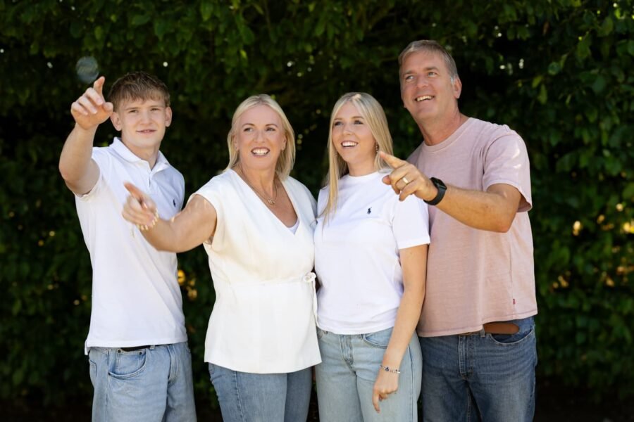 A family outdoors, a child pointing to the sky