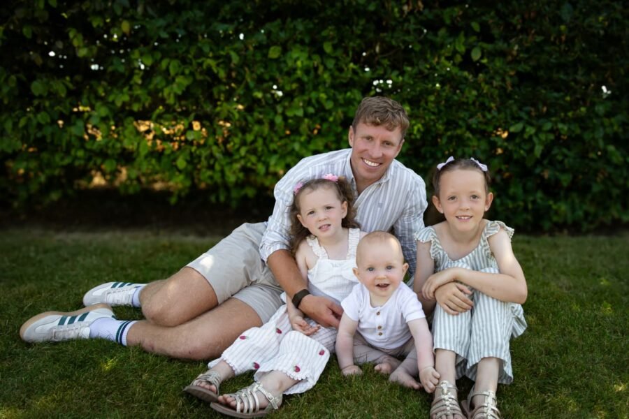 A father with his children on the grass